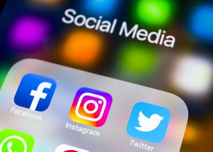 Sankt-Petersburg Russia, March 6, 2018: Apple iPhone X on office desk with icons of social media facebook, instagram, twitter, snapchat application on screen. Social network. Starting social media app. Photo taken at company office